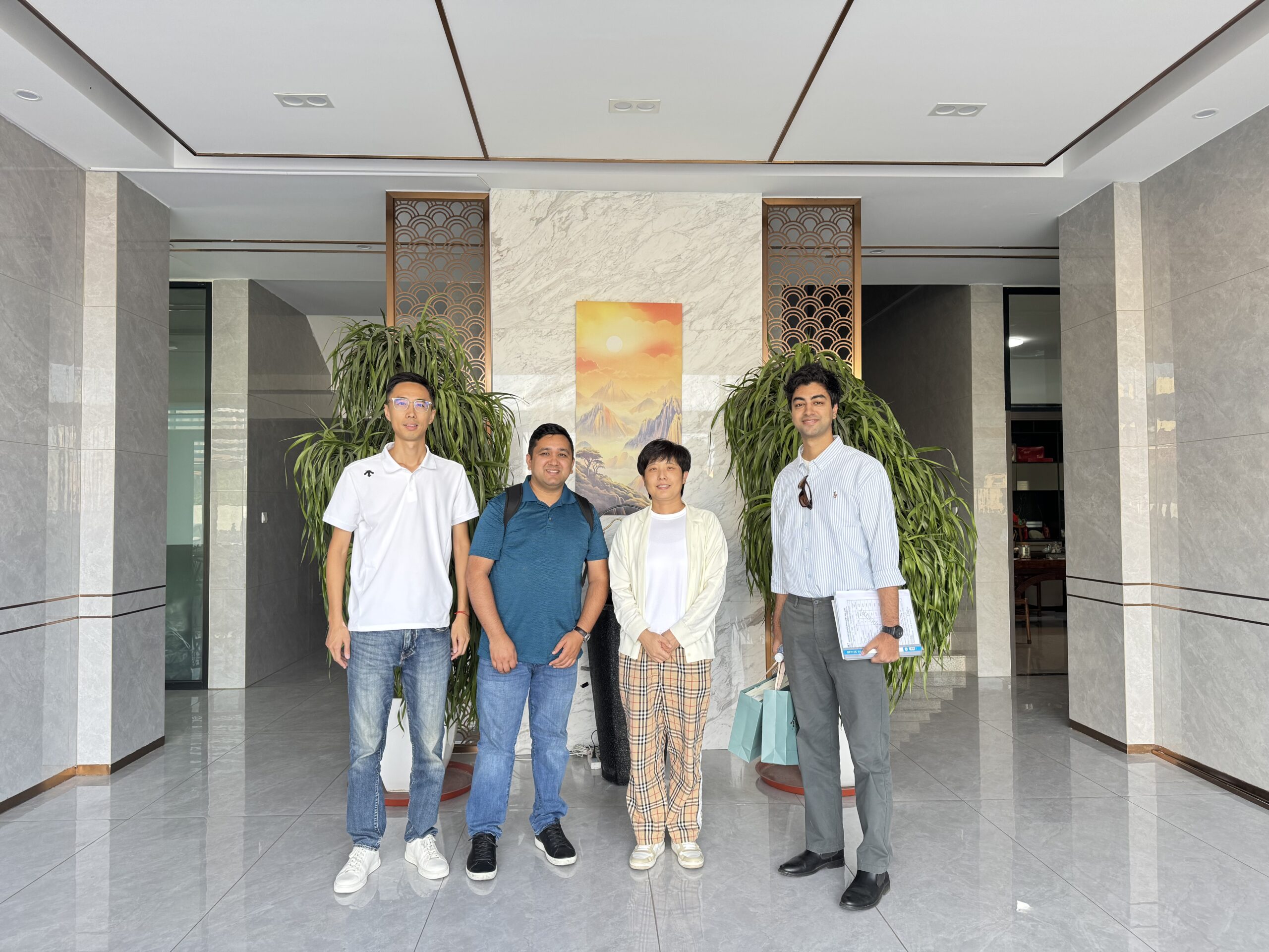Nepal customers visiting LEBON textile machinery factory in Qingdao, China, inspecting the microfiber polyester wadding production line.